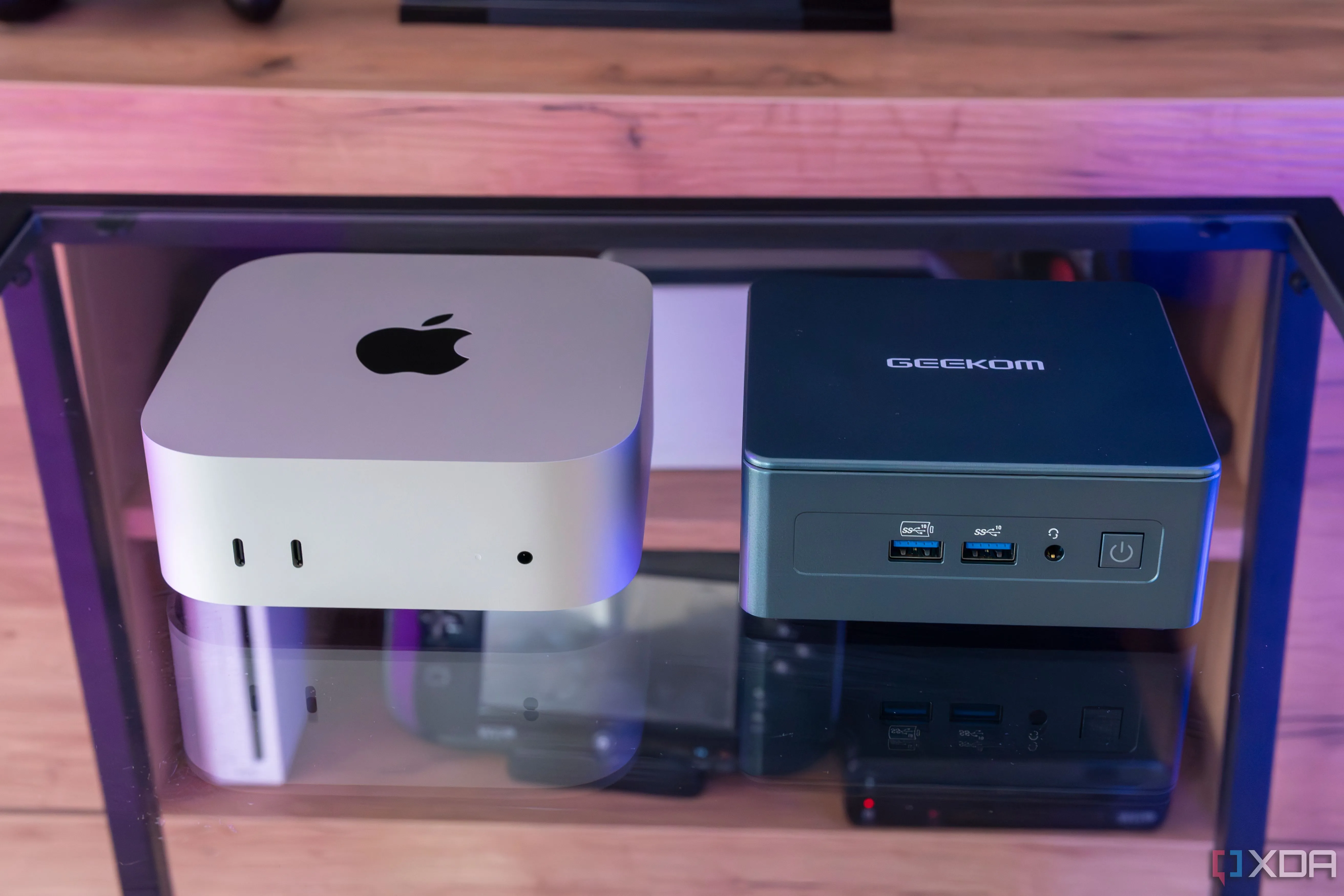 Máy Mac Mini M4 đặt cạnh một máy tính mini Geekom, đại diện cho thiết bị chạy macOS mới