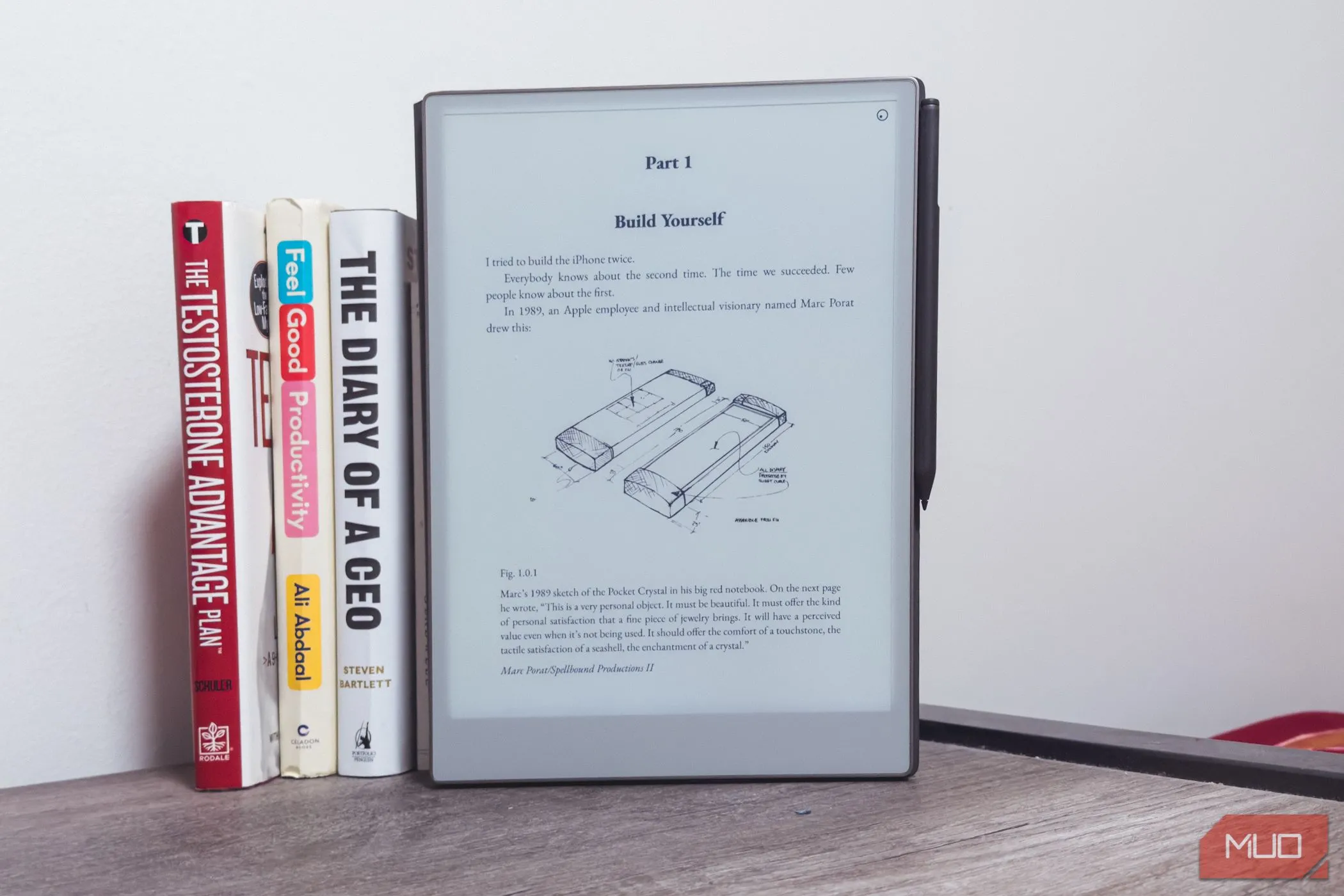 Máy tính bảng reMarkable Paper Pro với thiết kế sang trọng, đặt cạnh một chồng sách trên bàn gỗ, minh họa kích thước lớn hơn của thiết bị.